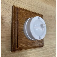Single 2 way Bakelite switch on a square oak pattress
