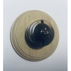 Single 2 way Bakelite switch on circular oak pattress