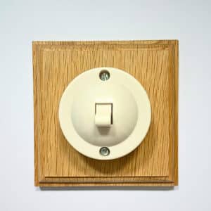 single 2 way bakelite switch on a square oak pattress