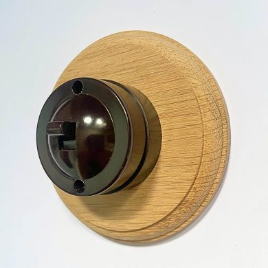single 2 way bakelite switch on circular oak pattress